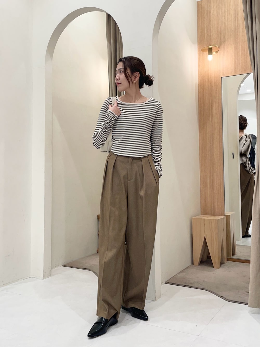 ホワイト系のTシャツ/カットソー、ホワイト系のショルダーバッグ、ブラウン系のその他パンツを着用したレディースの冬コーディネートの4枚目の写真