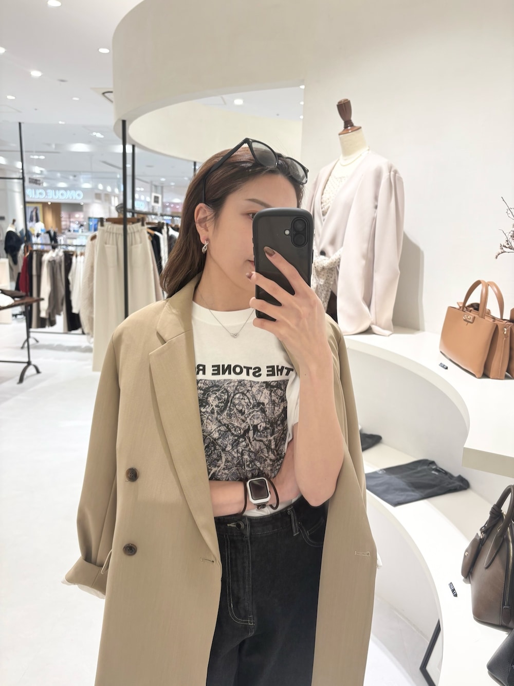 ベージュ系のテーラードジャケット、ホワイト系のTシャツ/カットソー、ブラック系のデニムパンツを着用したレディースの春コーディネートの2枚目の写真