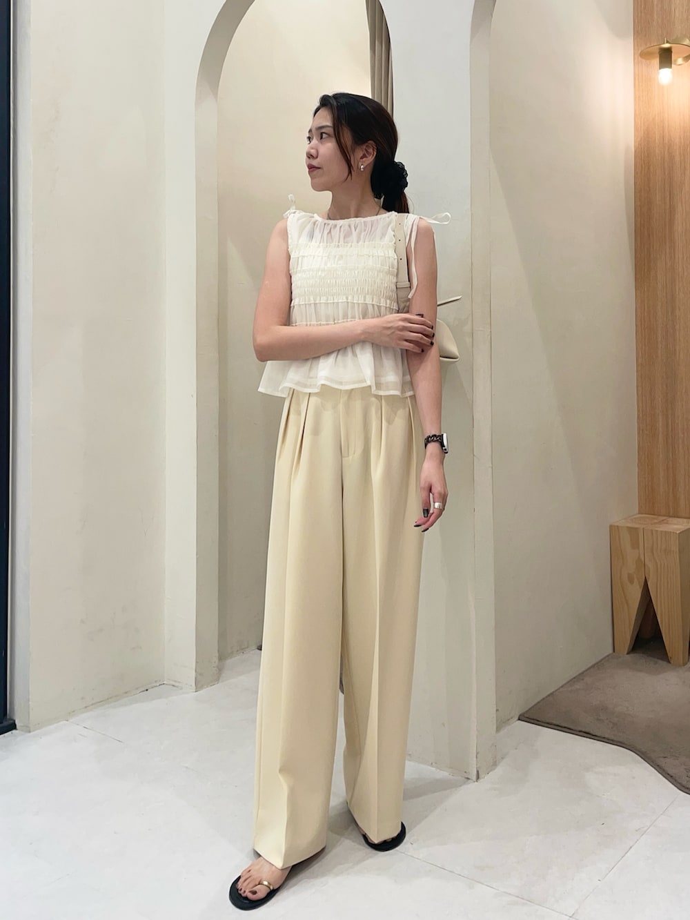 ホワイト系のシャツ/ブラウス、イエロー系のその他パンツ、ブラック系のパンプスを着用したレディースの夏コーディネートの3枚目の写真