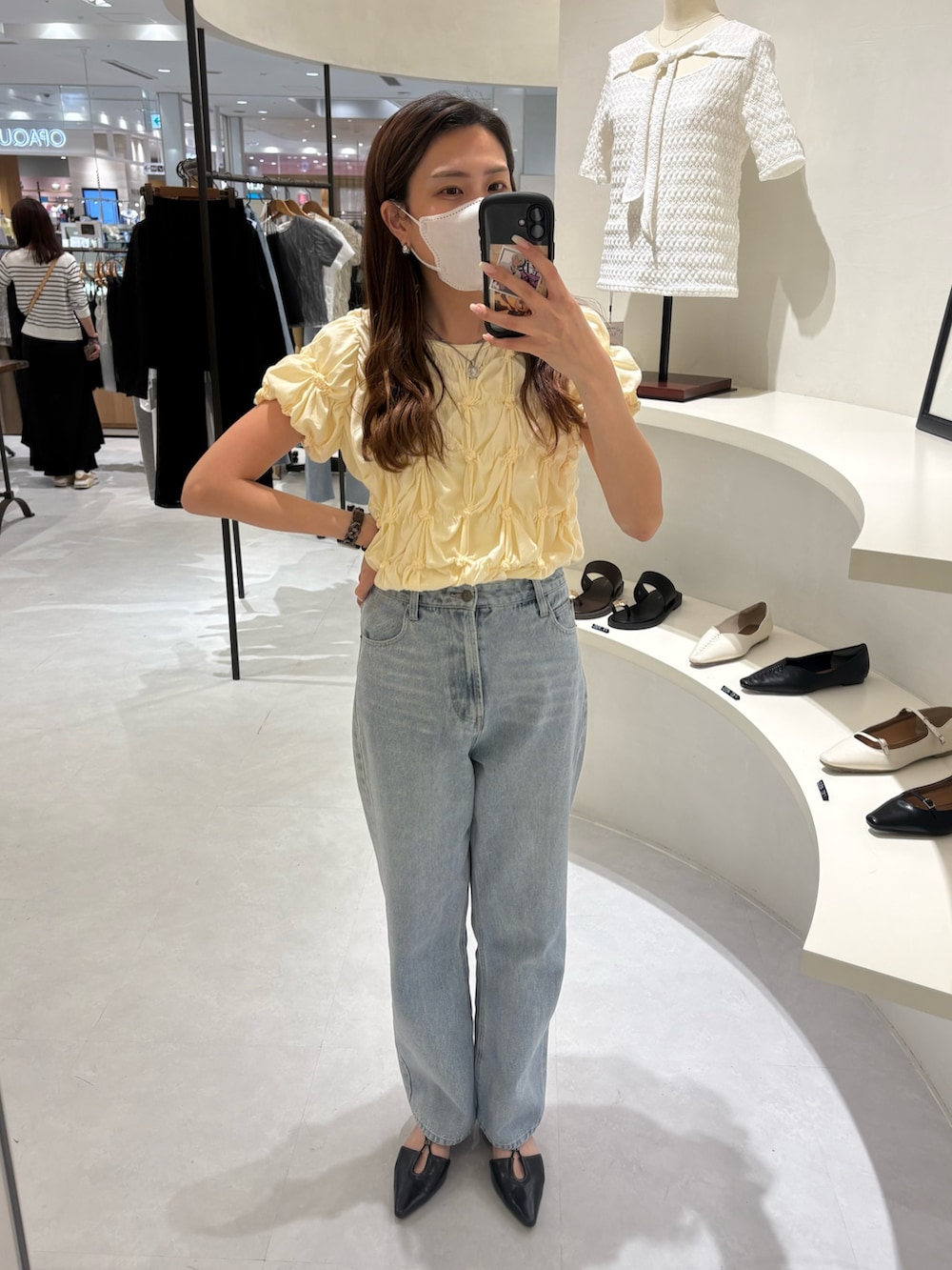 イエロー系のTシャツ/カットソー、ブラック系のショルダーバッグ、ブルー系のデニムパンツを着用したレディースの春コーディネートの2枚目の写真