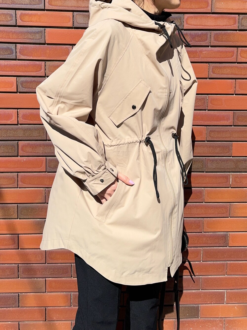 ベージュ系のジャケット/アウター、ブラック系のショルダーバッグ、ブラック系のスニーカーを着用したレディースの春コーディネートの5枚目の写真