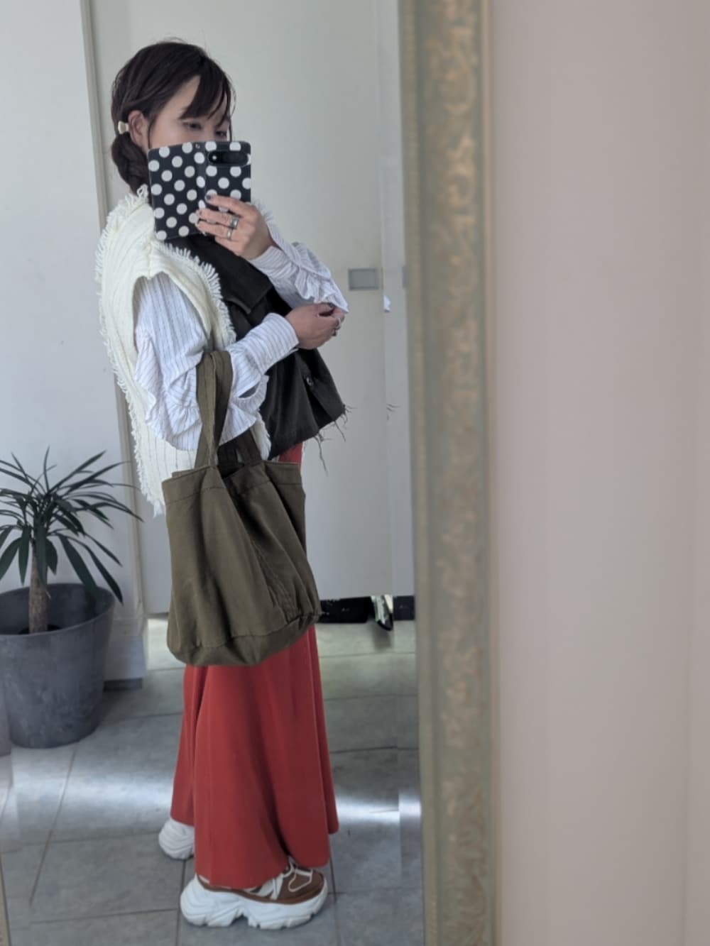 グリーン系のニット/セーターを着用したレディースの冬コーディネートの3枚目の写真