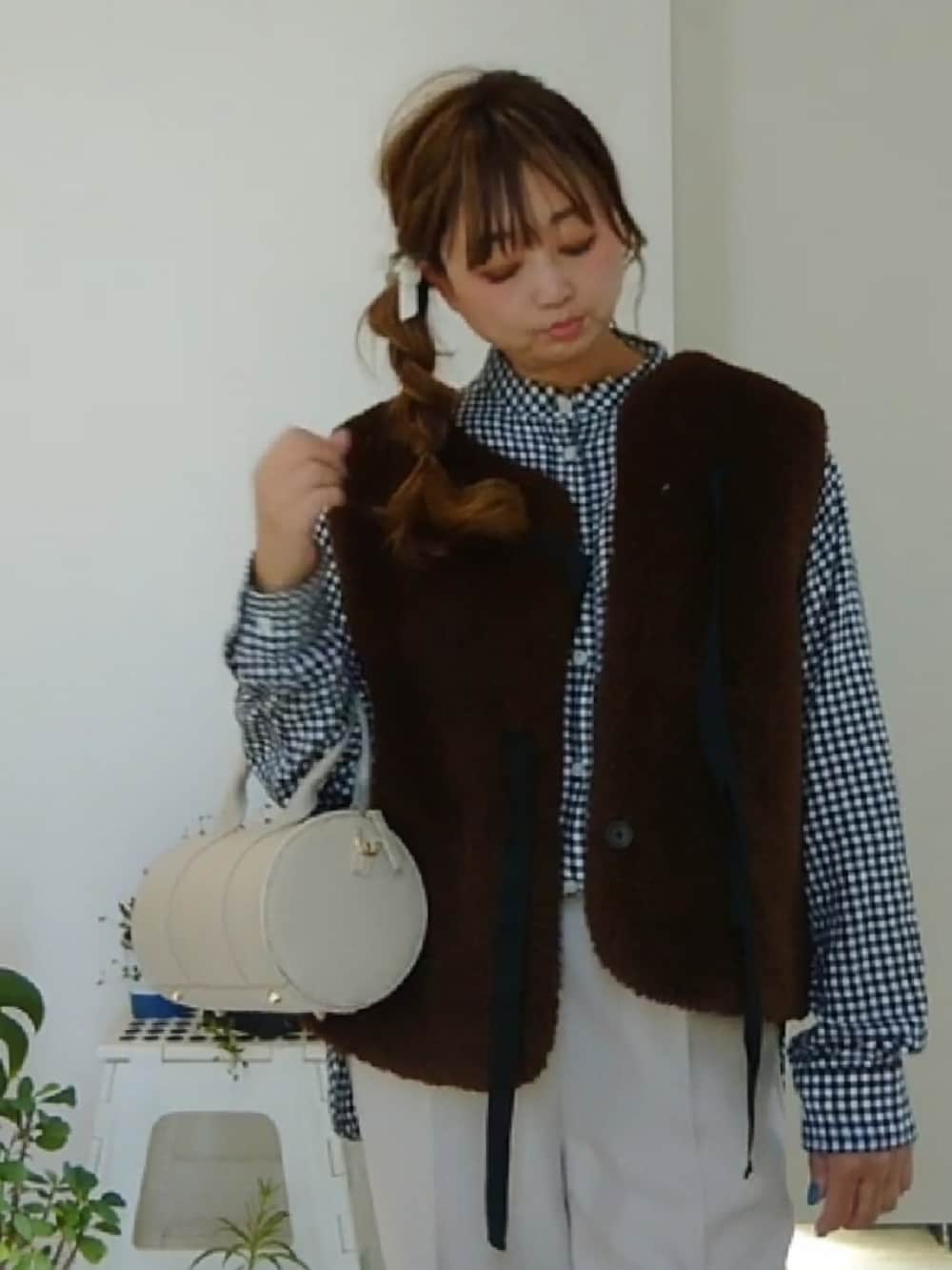 ブラウン系のベスト、ブラック系のシャツ/ブラウス、ホワイト系のその他パンツを着用したレディースの冬コーディネートの2枚目の写真