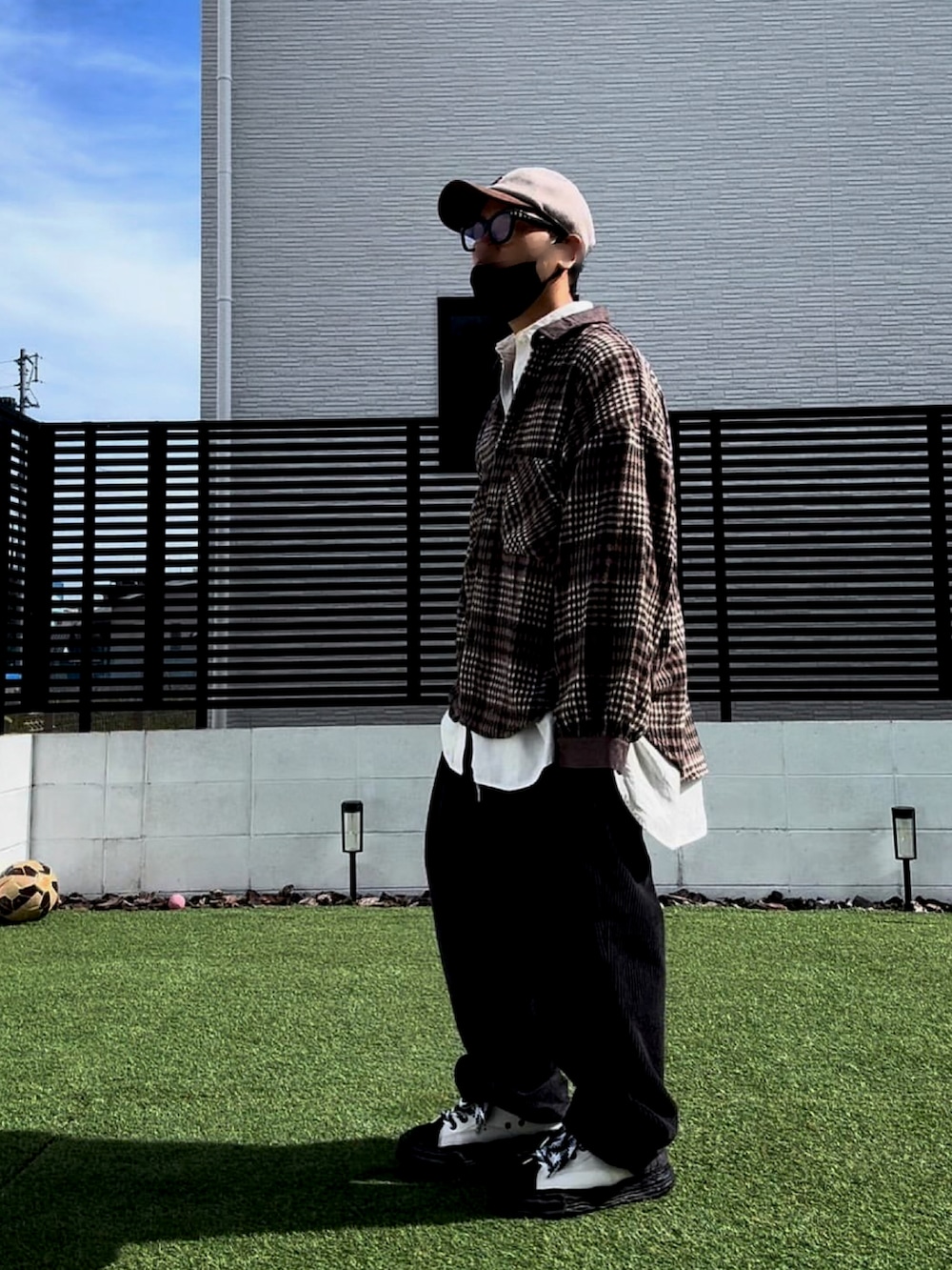 ブラウン系のシャツ/ブラウス、ブラック系のスラックス、ブラック系のスニーカーを着用したメンズの秋コーディネートの2枚目の写真