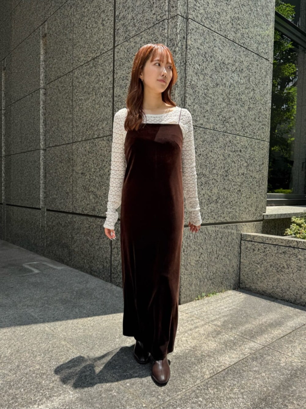 ブラウン系のワンピース、ブラウン系のブーツ、ホワイト系のTシャツ/カットソーを着用したレディースの秋コーディネートの4枚目の写真