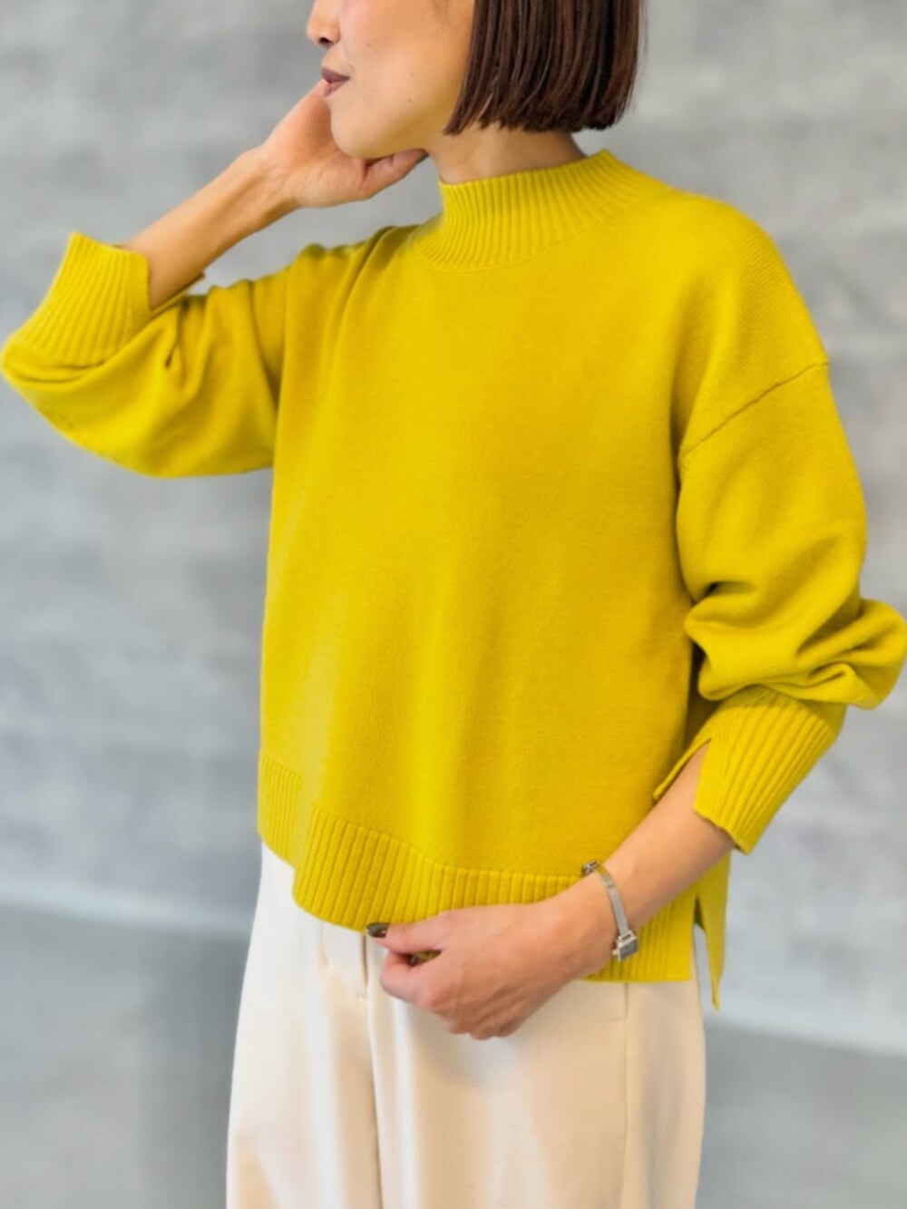 ホワイト系のその他パンツ、イエロー系のニット/セーターを着用したレディースの秋コーディネートの2枚目の写真