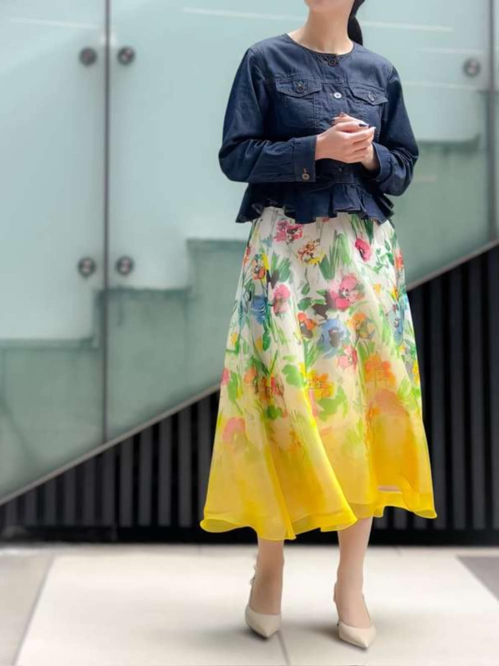 イエロー系のスカート、ブルー系のデニムジャケットを着用したレディースの春コーディネートの4枚目の写真