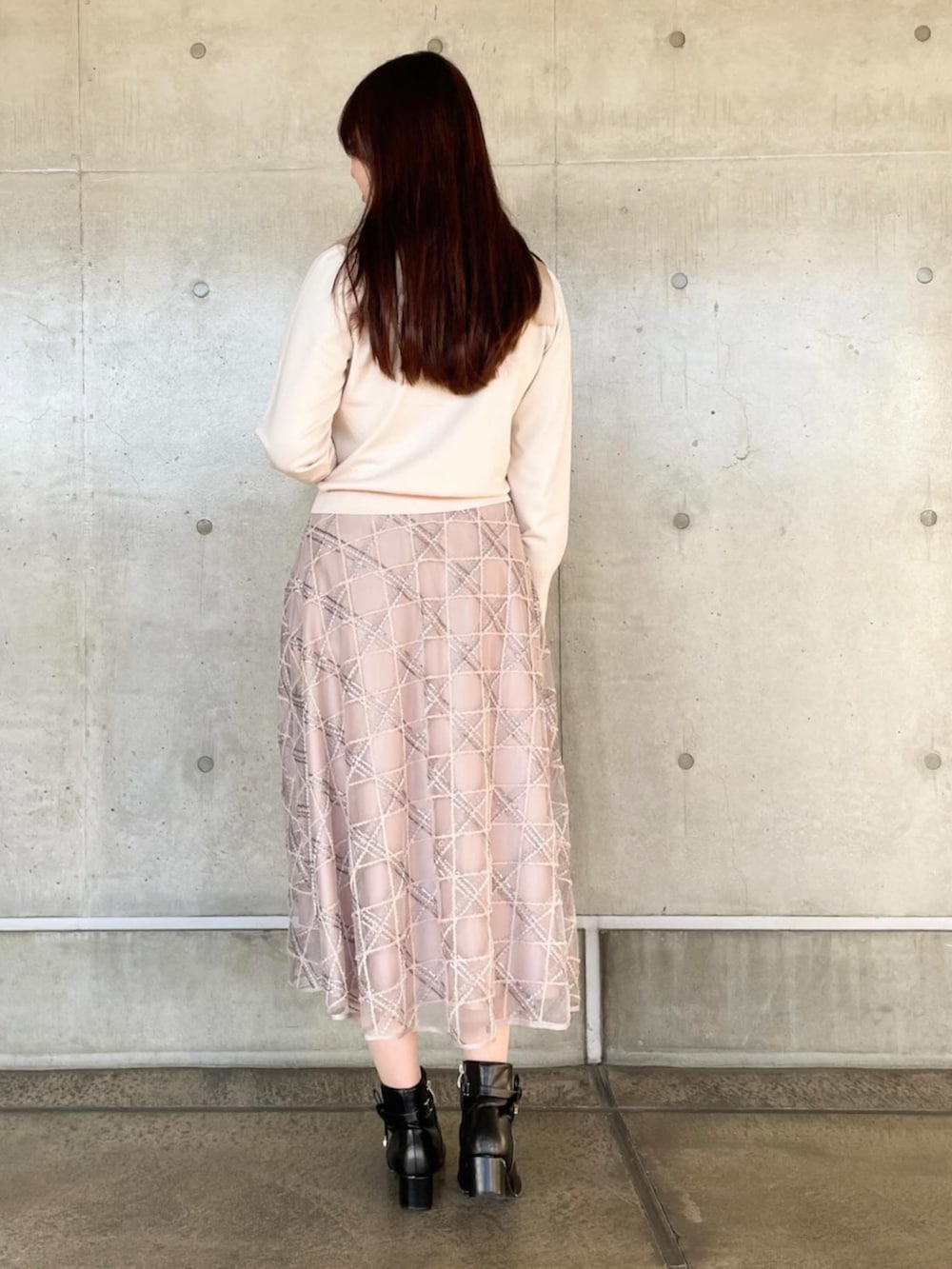 ピンク系のスカート、ピンク系のニット/セーターを着用したレディースの冬コーディネートの2枚目の写真