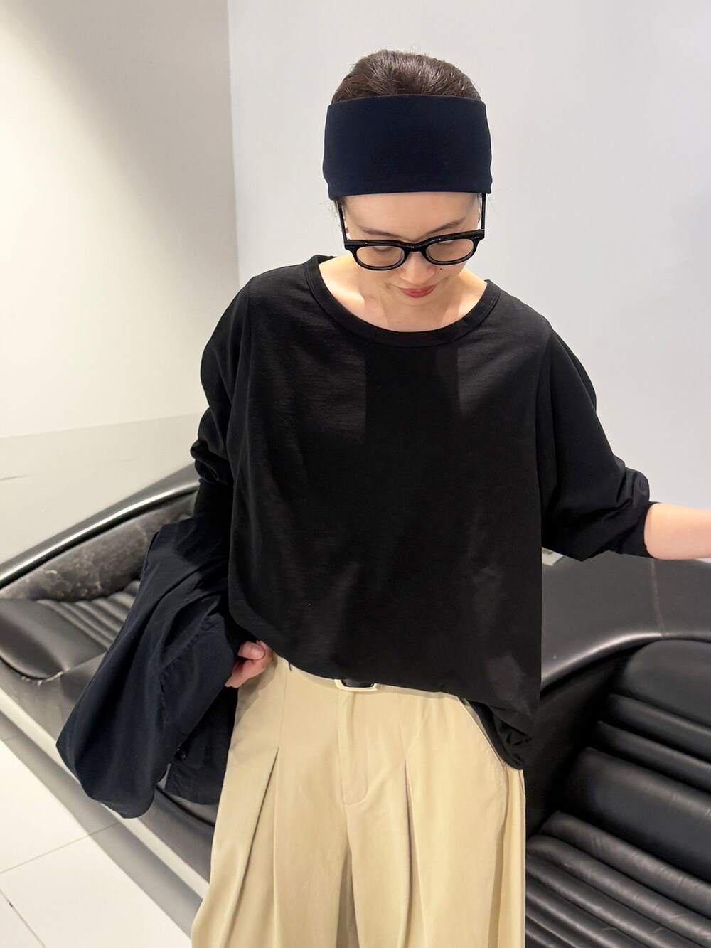ベージュ系のチノパンツ、ブラック系のその他アウター、ブラック系のTシャツ/カットソーを着用したレディースの冬コーディネートの7枚目の写真