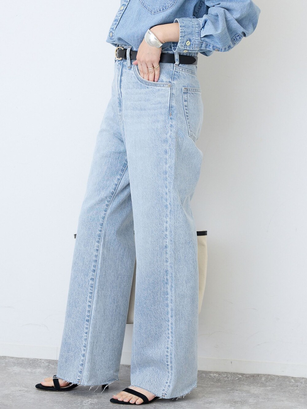 ブルー系のデニムパンツ、ブルー系のシャツ/ブラウス、ブラック系のサンダルを着用したレディースの夏コーディネートの5枚目の写真