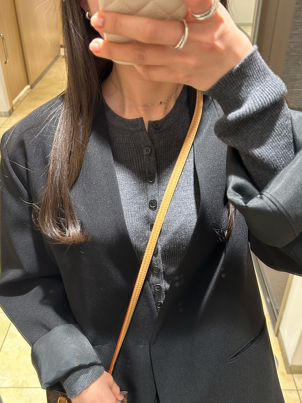 グレー系のカーディガン/ボレロ、ブラック系のスカート、ブラック系のブーツを着用したレディースの冬コーディネートの2枚目の写真