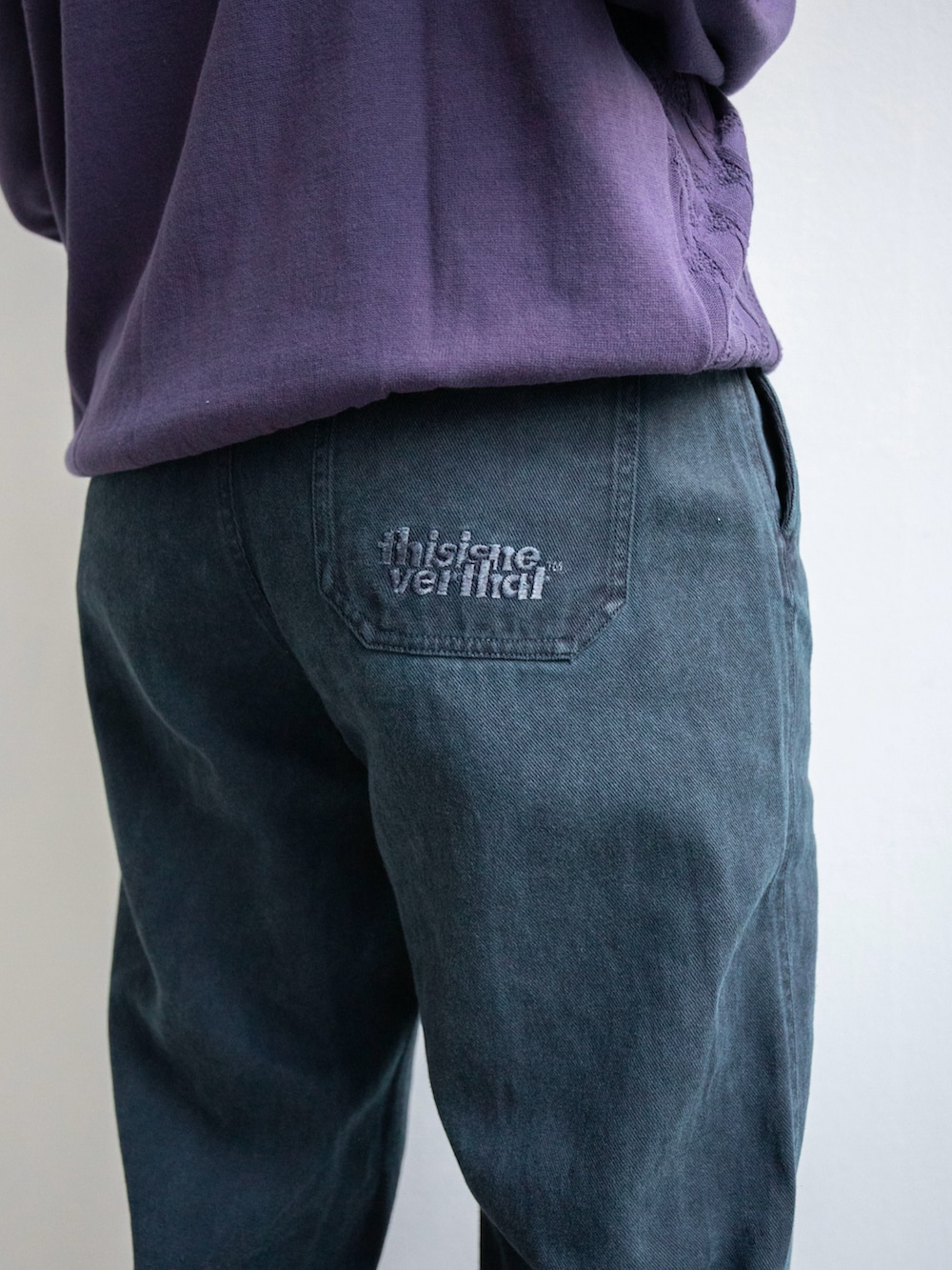 パープル系のニット/セーター、ブルー系のその他パンツを着用したレディースの冬コーディネートの3枚目の写真