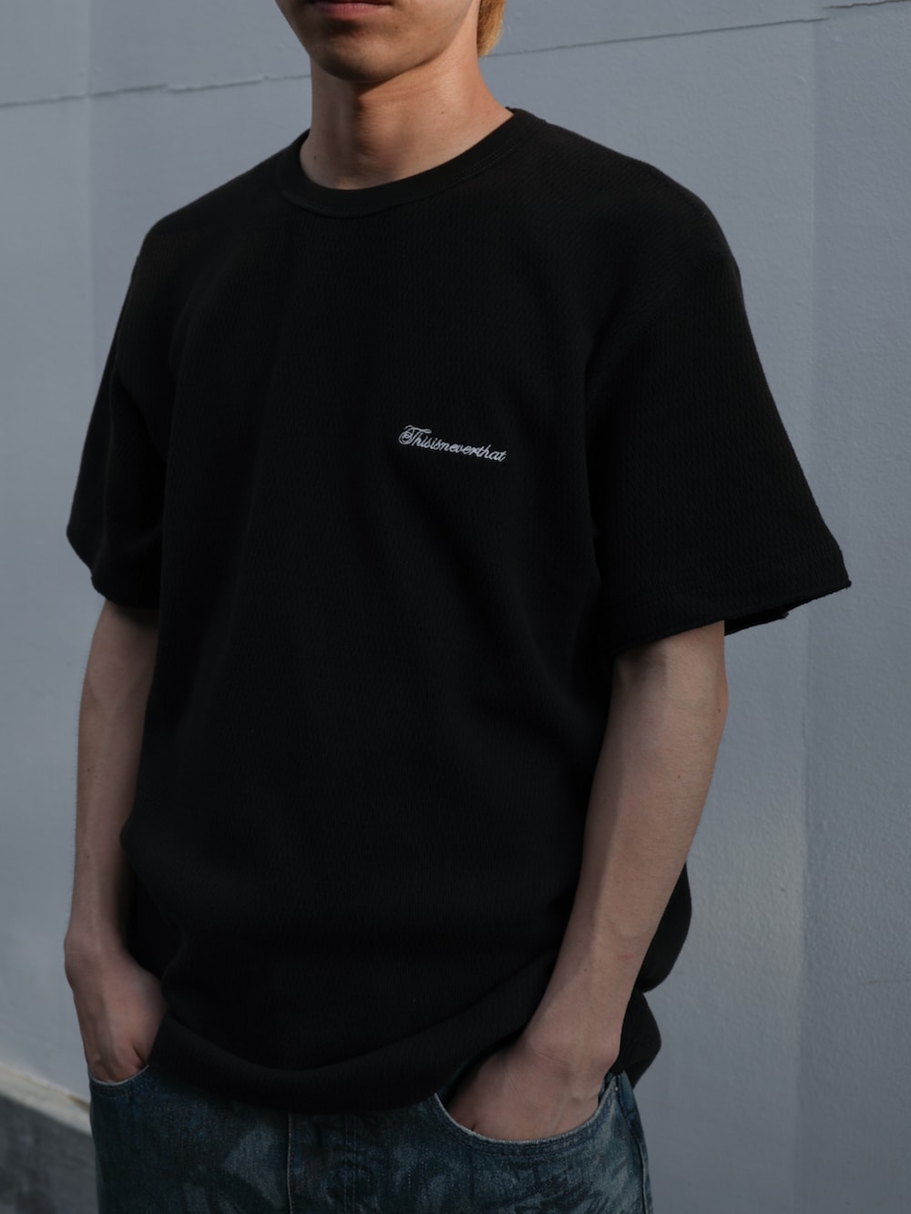 ブラック系のTシャツ/カットソー、ブルー系のデニムパンツ、ブラック系のキャップを着用したメンズの夏コーディネートの2枚目の写真