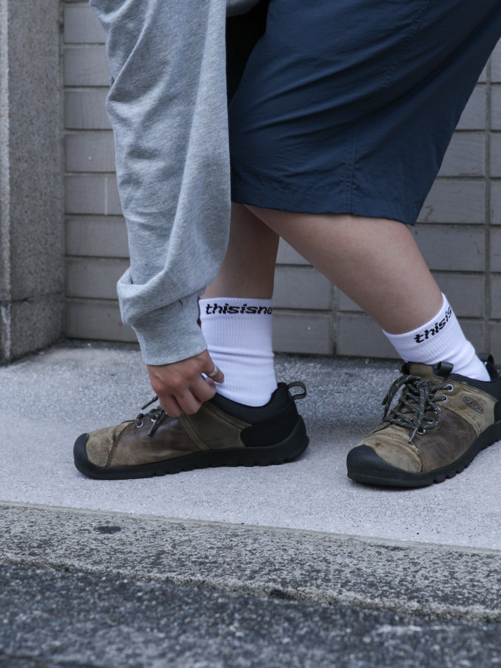 グレー系のTシャツ/カットソー、ブルー系のその他パンツ、ベージュ系のキャップを着用したレディースの夏コーディネートの7枚目の写真