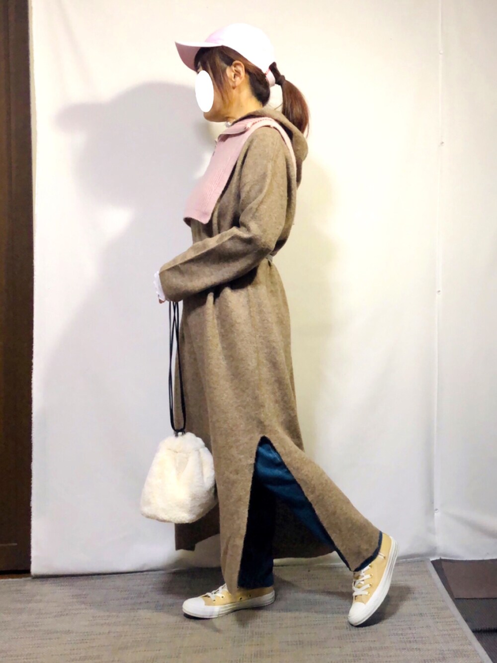 ベージュ系のワンピース、ピンク系のベスト、ホワイト系のTシャツ/カットソーを着用したレディースの冬コーディネートの3枚目の写真