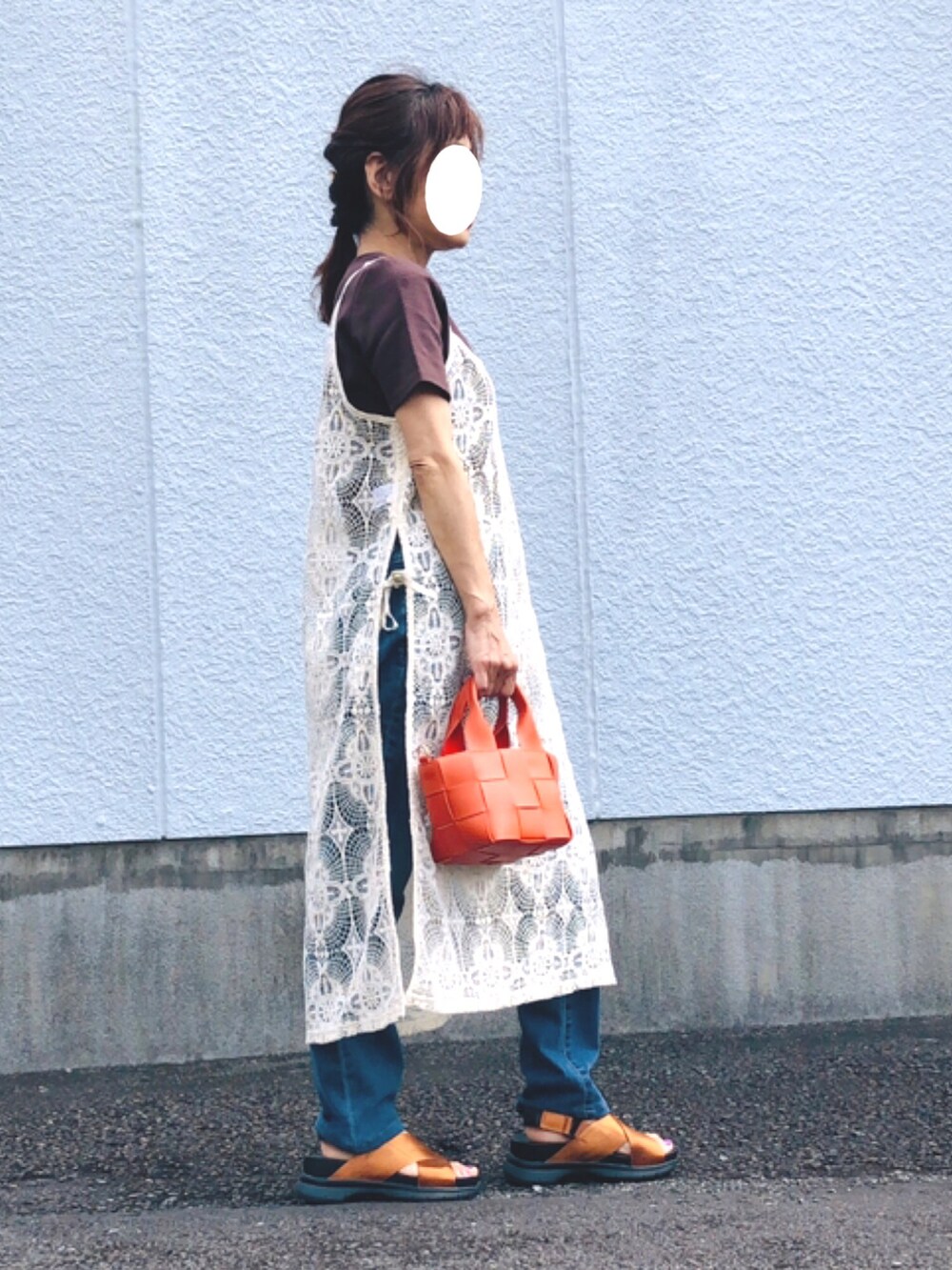 ホワイト系のワンピース、ブラウン系のTシャツ/カットソー、ブルー系のデニムパンツを着用したレディースの秋コーディネートの3枚目の写真