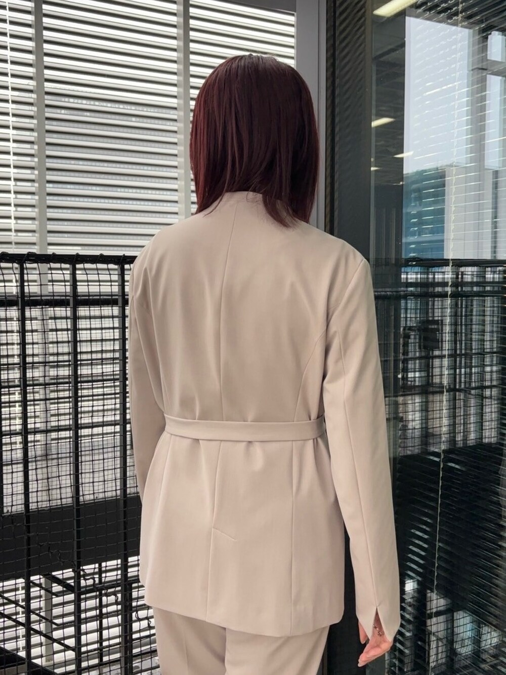 ブルー系のニット/セーター、ベージュ系のスラックス、ベージュ系のセットアップを着用したレディースの冬コーディネートの9枚目の写真