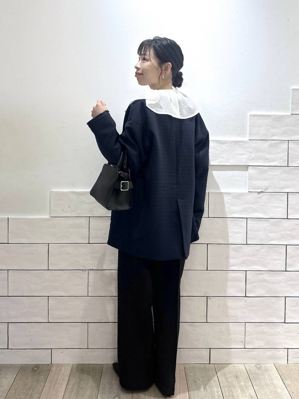 ブラック系のその他パンツ、ブルー系のノーカラージャケット、ホワイト系のシャツ/ブラウスを着用したレディースの冬コーディネートの3枚目の写真