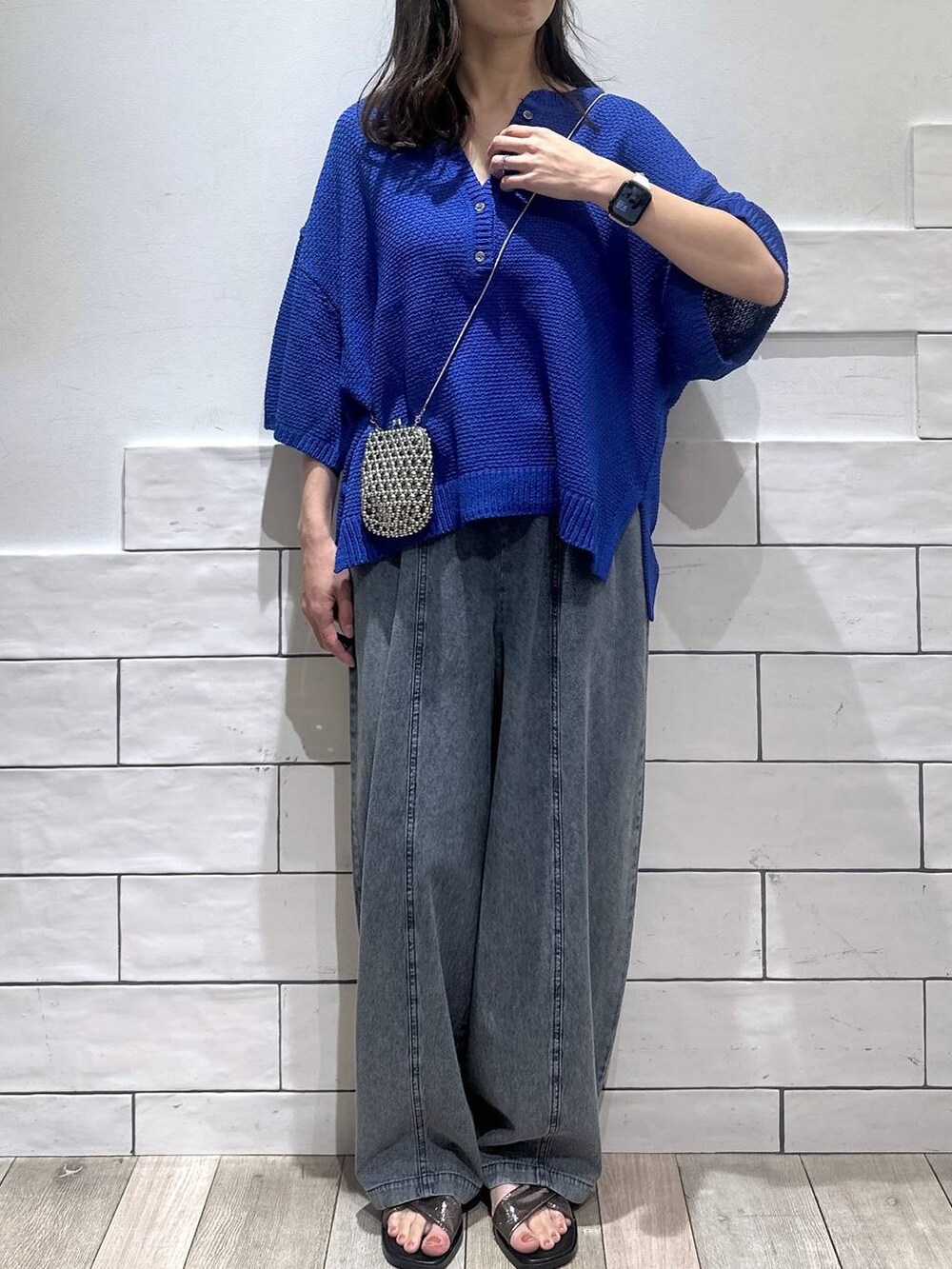 ブルー系のデニムパンツ、その他のサンダル、ブルー系のニット/セーターを着用したレディースの夏コーディネートの4枚目の写真
