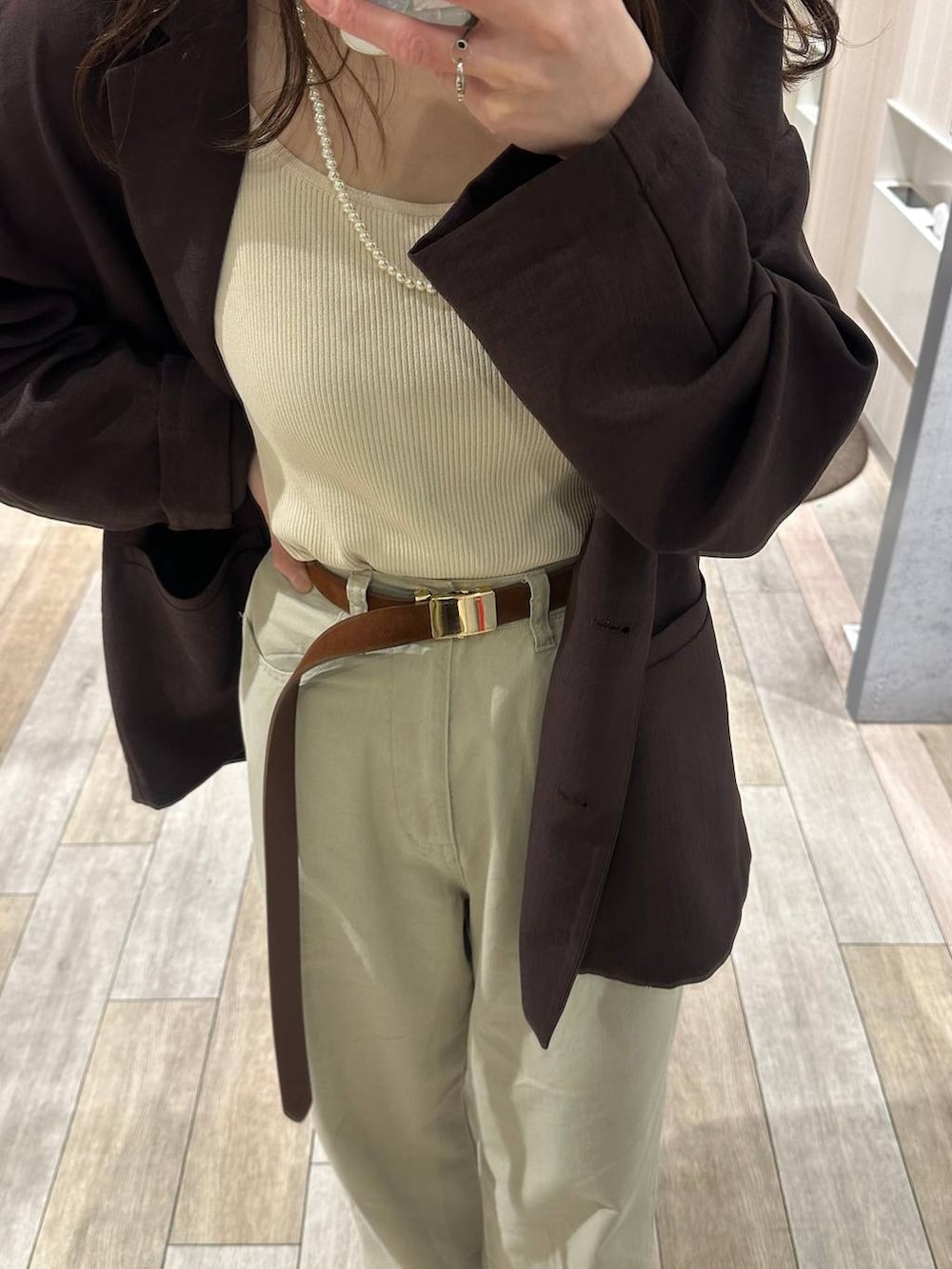 ブラウン系のテーラードジャケット、ブラウン系のベルトを着用したレディースの春コーディネートの2枚目の写真
