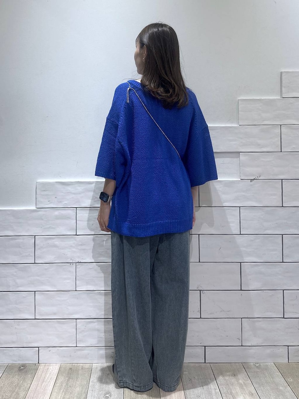 ブルー系のデニムパンツ、その他のサンダル、ブルー系のニット/セーターを着用したレディースの夏コーディネートの3枚目の写真