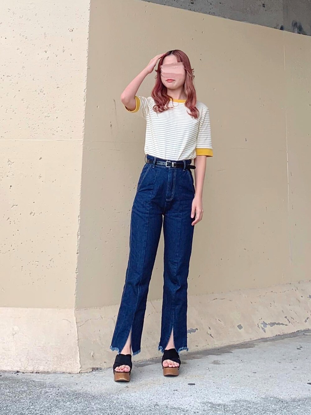 イエロー系のトップス、ブルー系のデニムパンツ、ブラック系のデニムパンツを着用したレディースの秋コーディネートの3枚目の写真