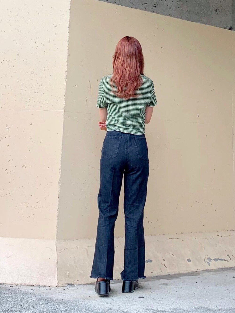 グリーン系のトップス、グリーン系のニット/セーター、ブラック系のデニムパンツを着用したレディースの夏コーディネートの5枚目の写真