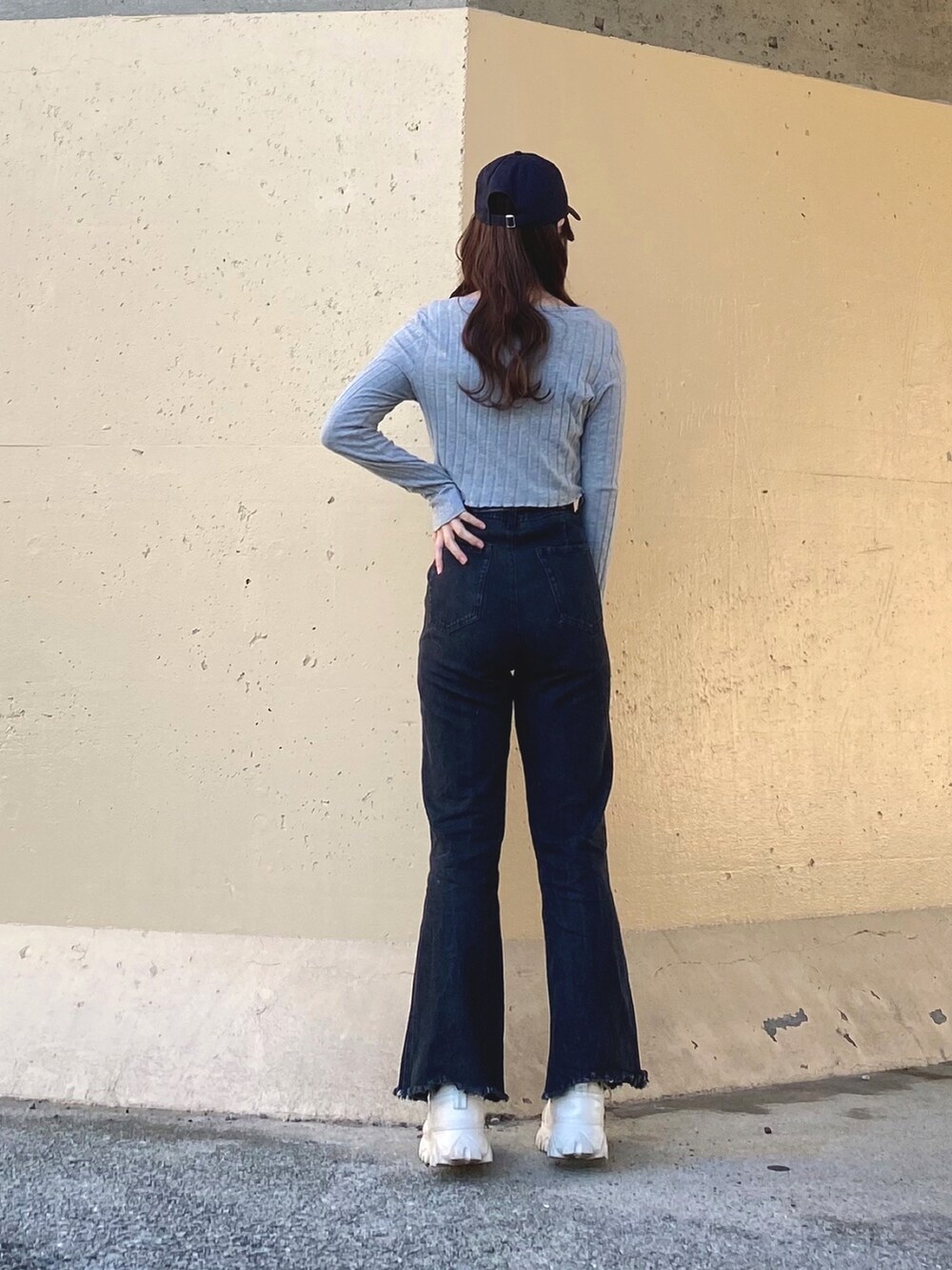 ブラック系のトップス、ブラック系のキャミソール、ブルー系のデニムパンツを着用したレディースの春コーディネートの4枚目の写真