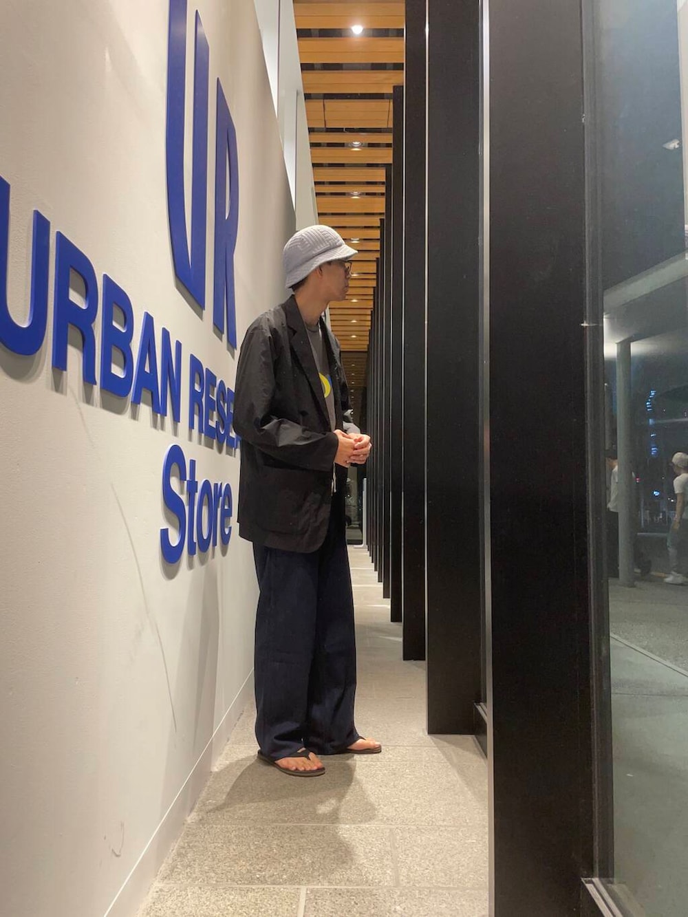 ブラック系のサンダル、ブラック系のその他アウター、ブルー系のデニムパンツを着用したメンズの夏コーディネートの2枚目の写真