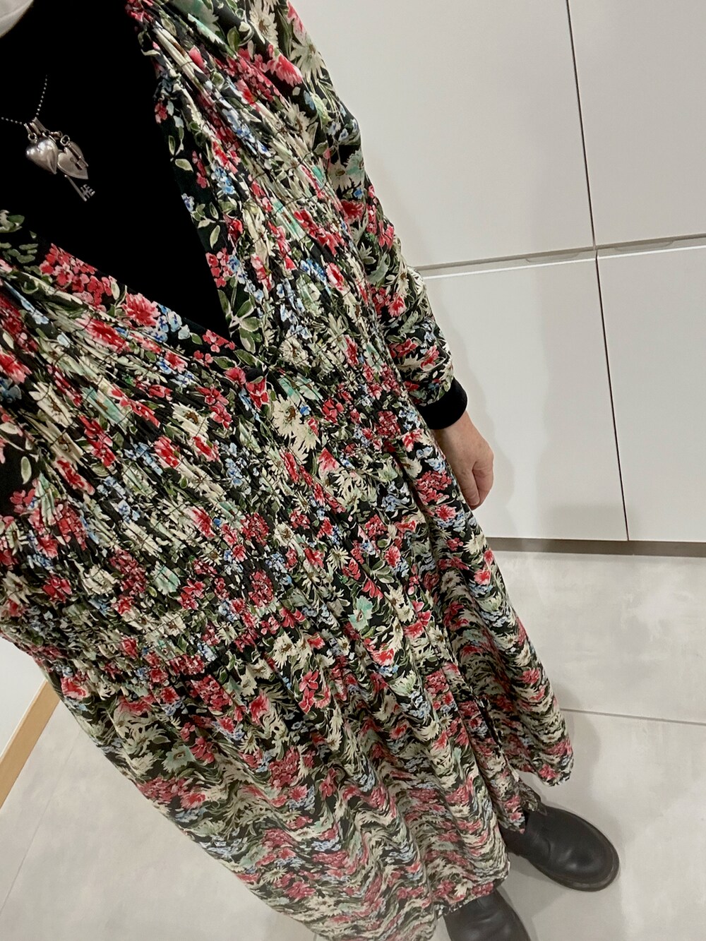 レッド系のワンピース、ブラック系のジャケット/アウター、ブラック系のTシャツ/カットソーを着用したレディースの冬コーディネートの2枚目の写真