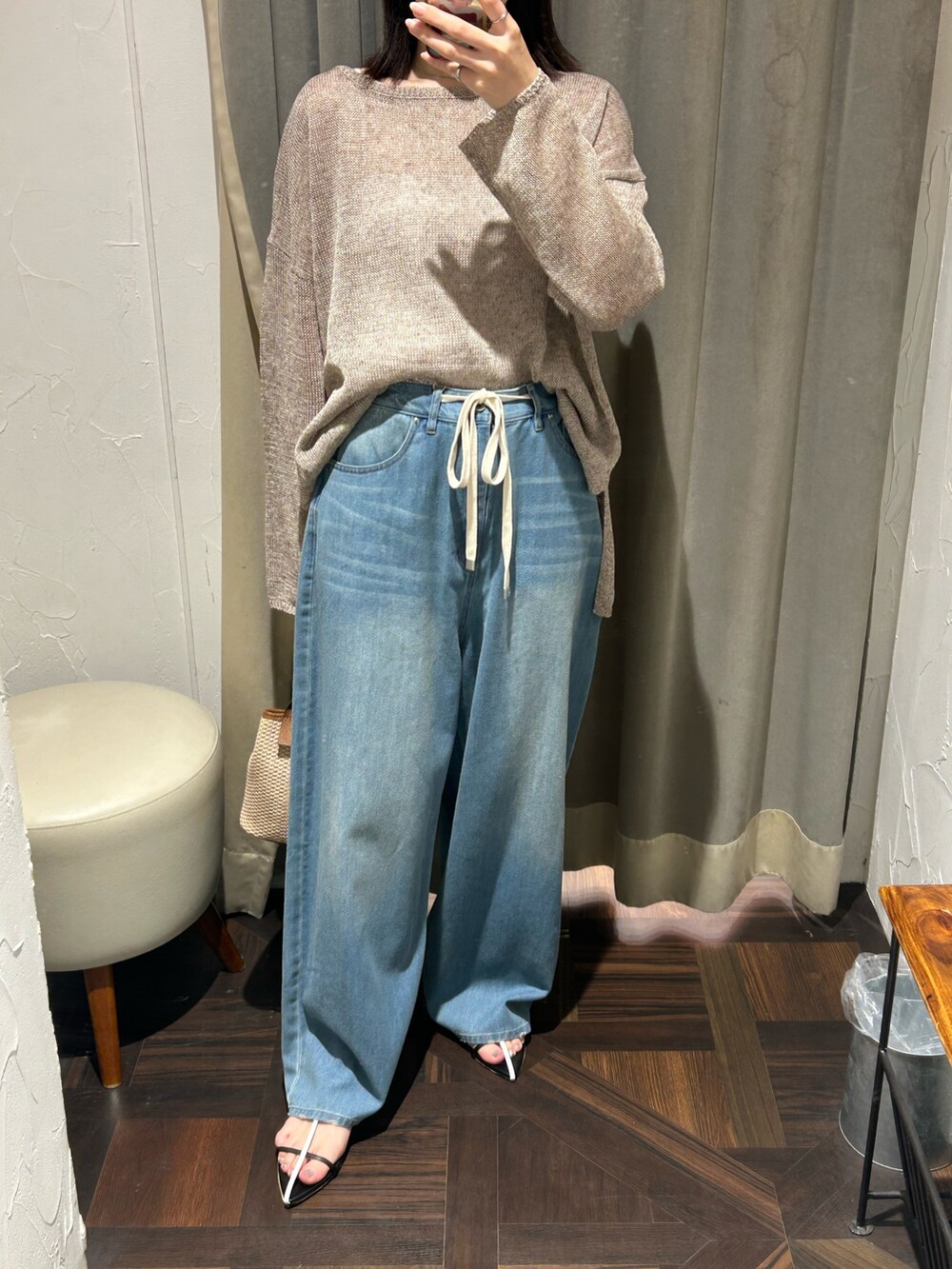 ブラウン系のニット/セーター、ブルー系のデニムパンツを着用したレディースの夏コーディネートの4枚目の写真