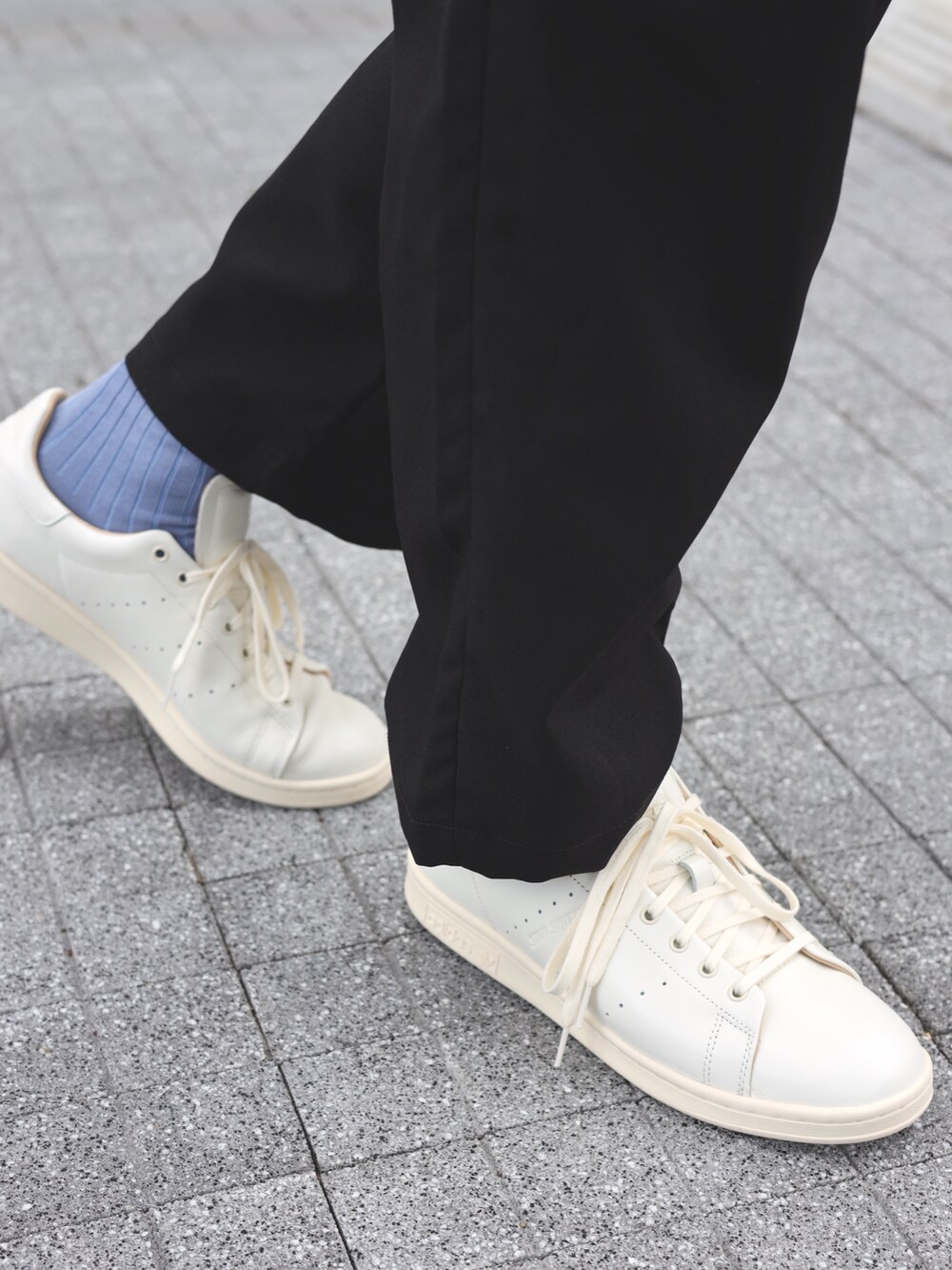 ブルー系のポロシャツ、ブラック系のショルダーバッグ、ホワイト系のスニーカーを着用したメンズの夏コーディネートの5枚目の写真