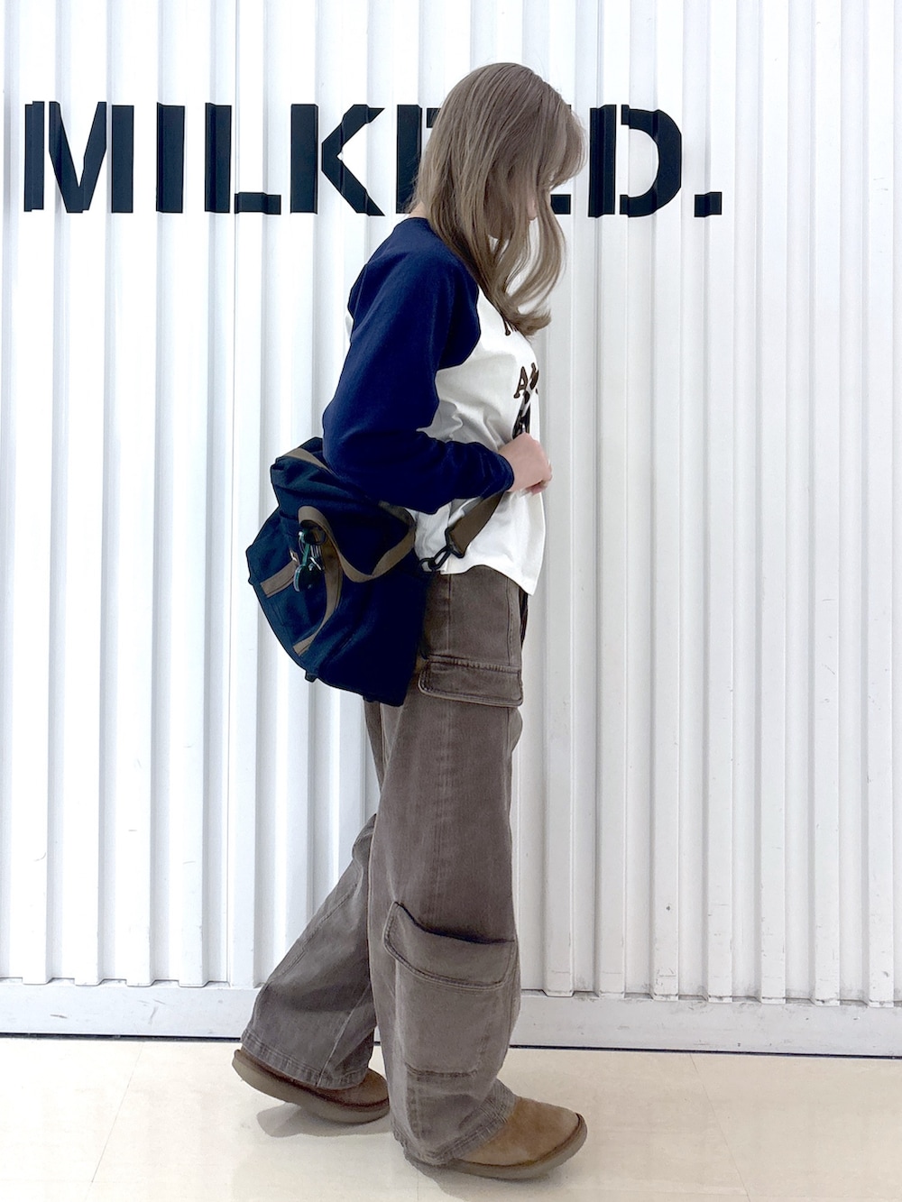 ブラウン系のその他パンツ、ホワイト系のTシャツ/カットソー、ブルー系のショルダーバッグを着用したレディースの冬コーディネートの3枚目の写真