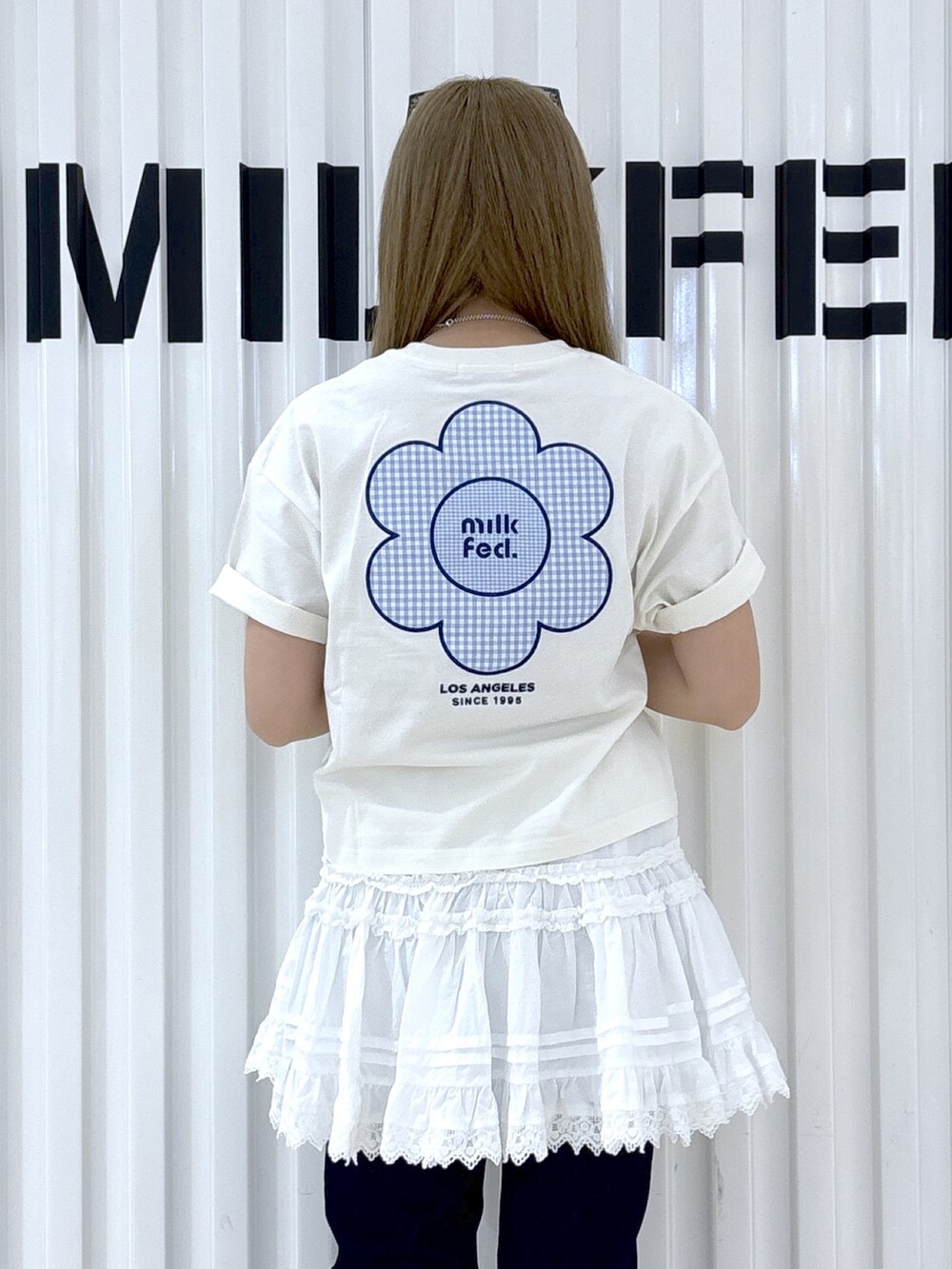 ホワイト系のTシャツ/カットソー、ホワイト系のスカート、ホワイト系のハンドバッグを着用したレディースの春コーディネートの6枚目の写真