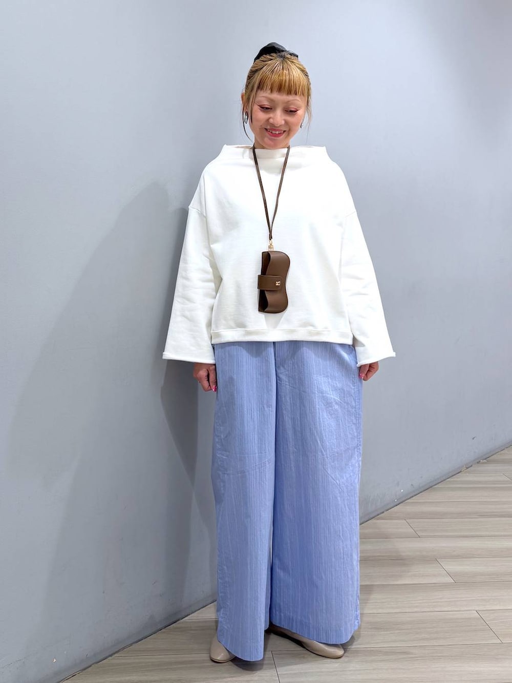 ホワイト系のスウェット、ブルー系のその他パンツ、ブラウン系のその他小物を着用したレディースの冬コーディネートの5枚目の写真