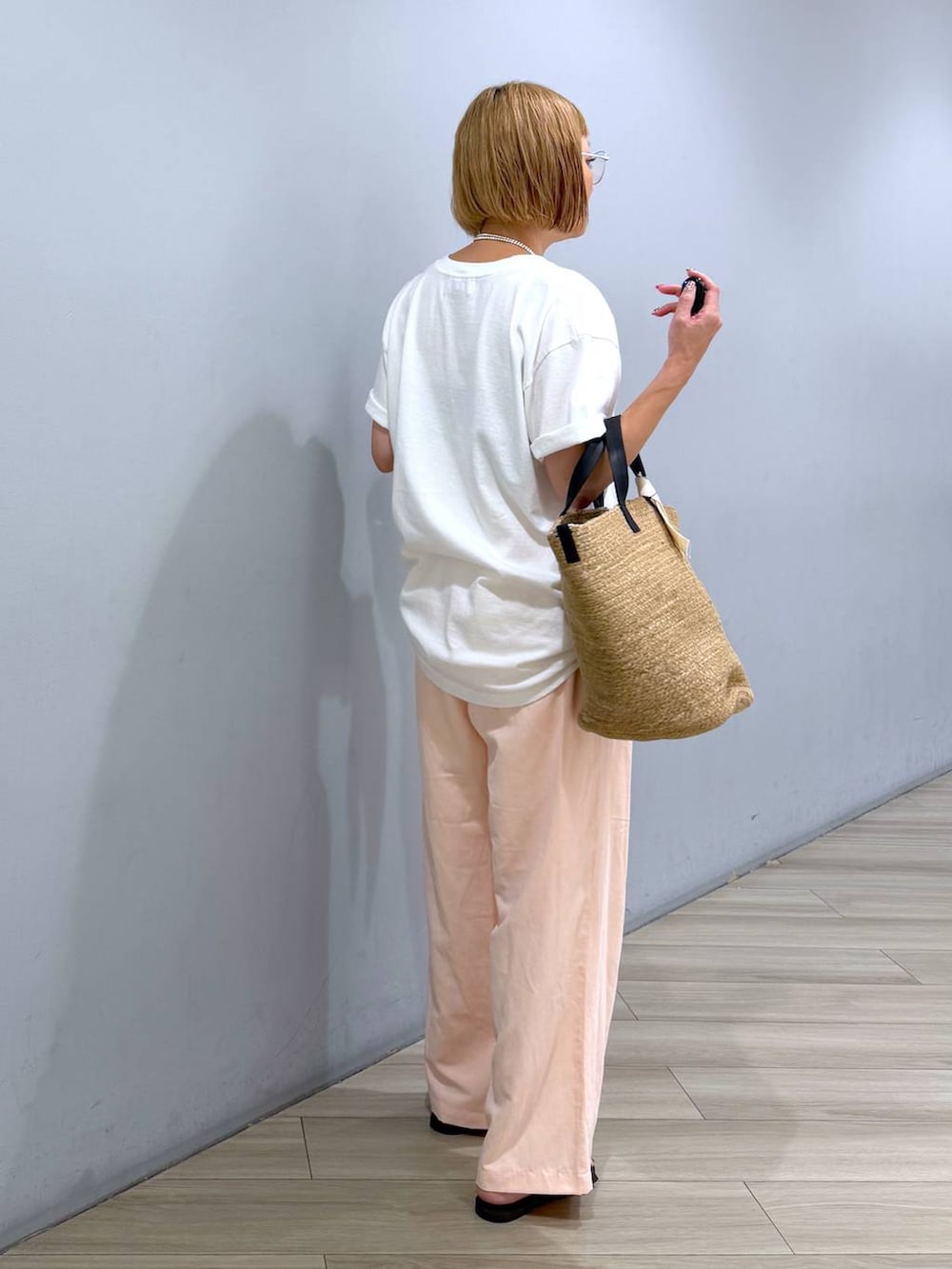 ホワイト系のTシャツ/カットソー、ピンク系のその他パンツ、ベージュ系のかごバッグを着用したレディースの秋コーディネートの5枚目の写真