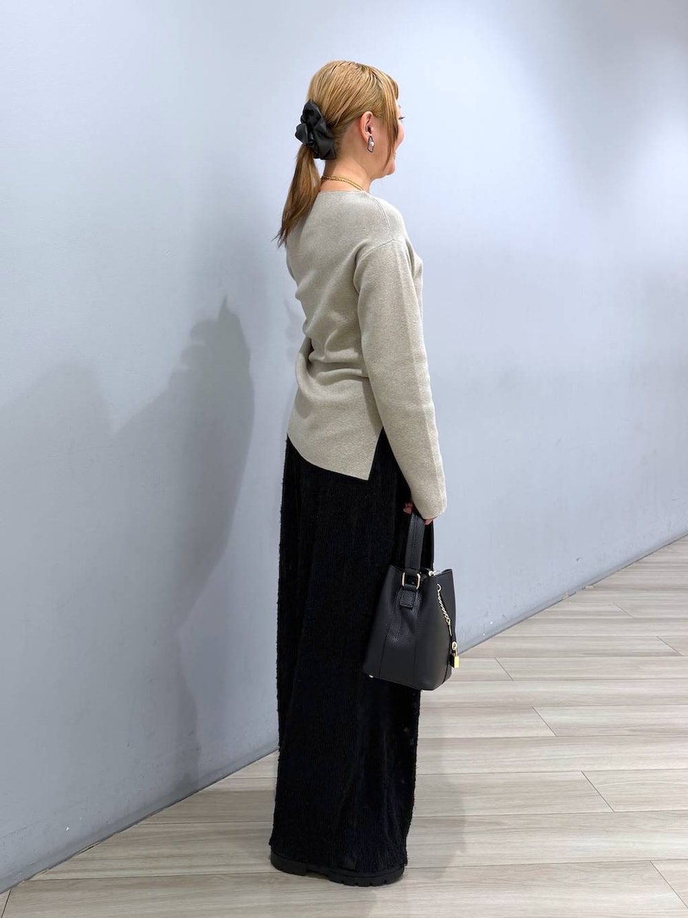 ブラック系のブーツ、ブラック系のその他パンツ、ブラック系のショルダーバッグを着用したレディースの冬コーディネートの2枚目の写真