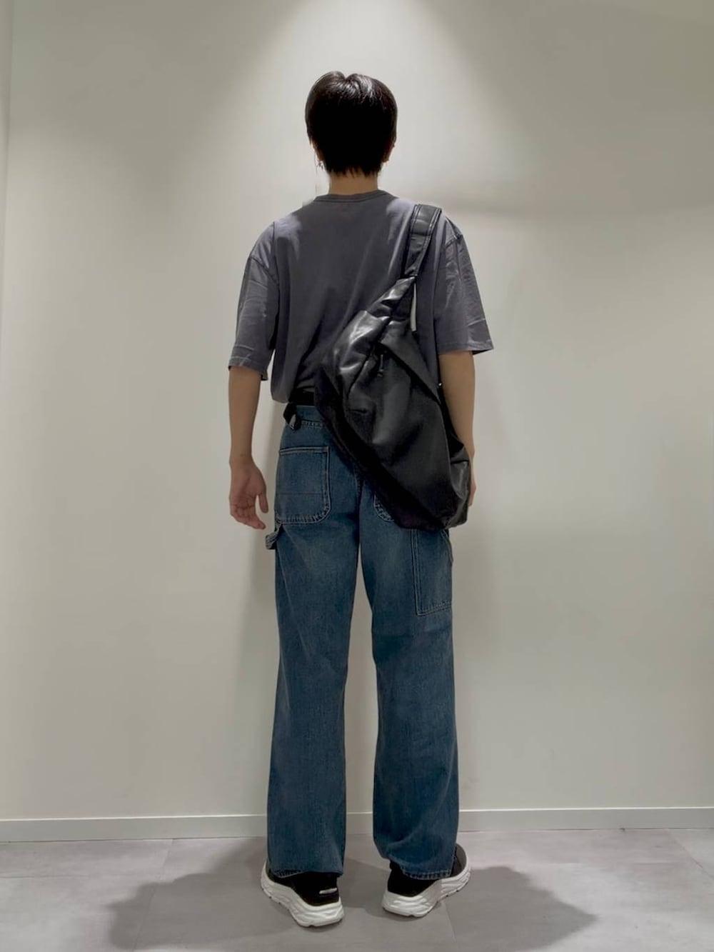 ブラック系のショルダーバッグ、ブラック系のサンダル、ブルー系のデニムパンツを着用したメンズの夏コーディネートの4枚目の写真