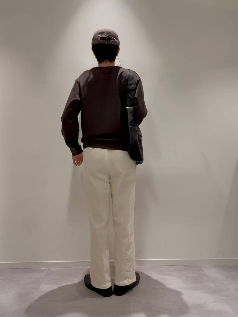 グレー系のその他シューズ、ホワイト系のその他パンツ、ブラック系のショルダーバッグを着用したメンズの秋コーディネートの3枚目の写真