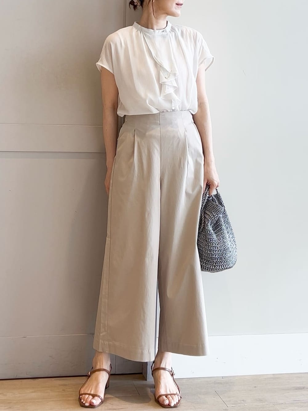 ホワイト系のシャツ/ブラウス、ベージュ系のその他パンツ、シルバー系のトートバッグを着用したレディースの夏コーディネートの4枚目の写真