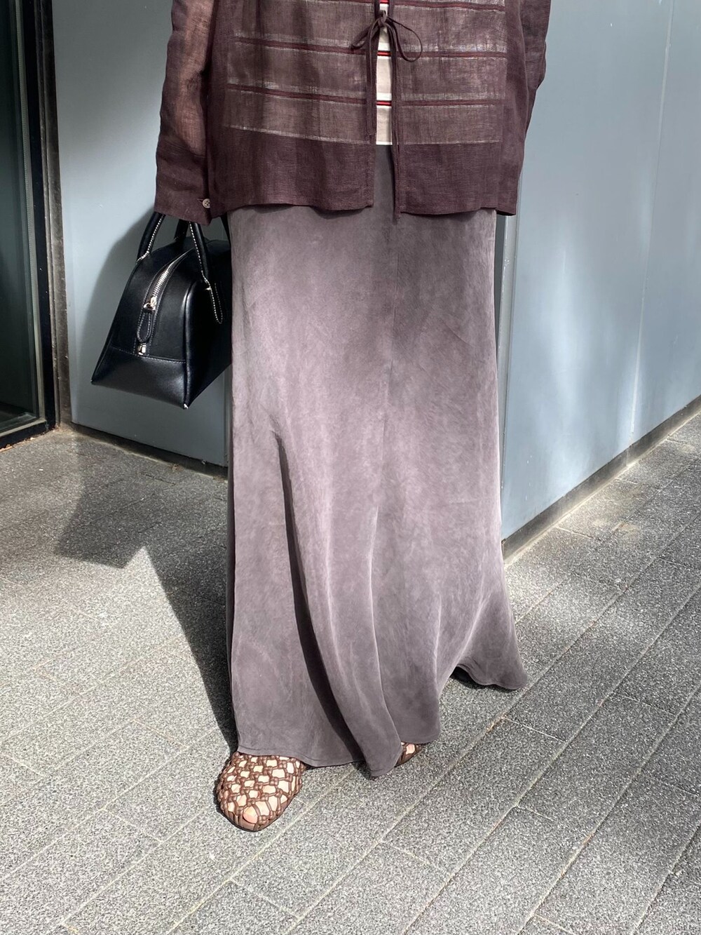 ブラウン系のシャツ/ブラウス、ブラウン系のスカート、ベージュ系のTシャツ/カットソーを着用したレディースの春コーディネートの4枚目の写真