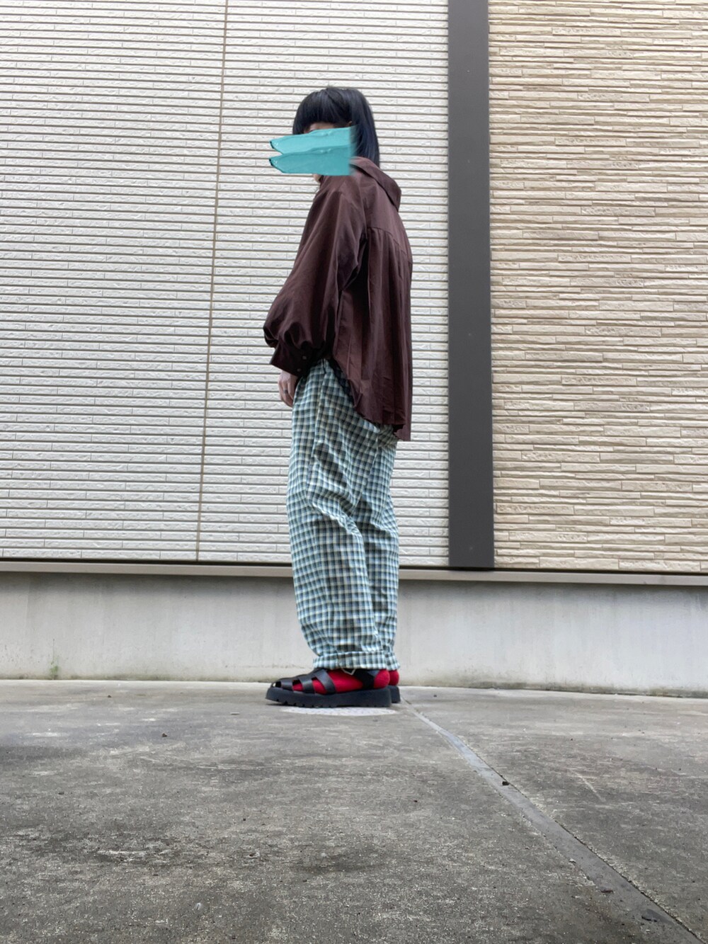 グリーン系のスラックス、ブラウン系のシャツ/ブラウス、ブラック系のサンダルを着用したレディースの春コーディネートの2枚目の写真