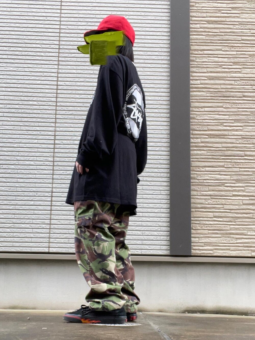 グリーン系のカーゴパンツ、ブラック系のTシャツ/カットソー、ブラック系のスニーカーを着用したレディースの春コーディネートの2枚目の写真