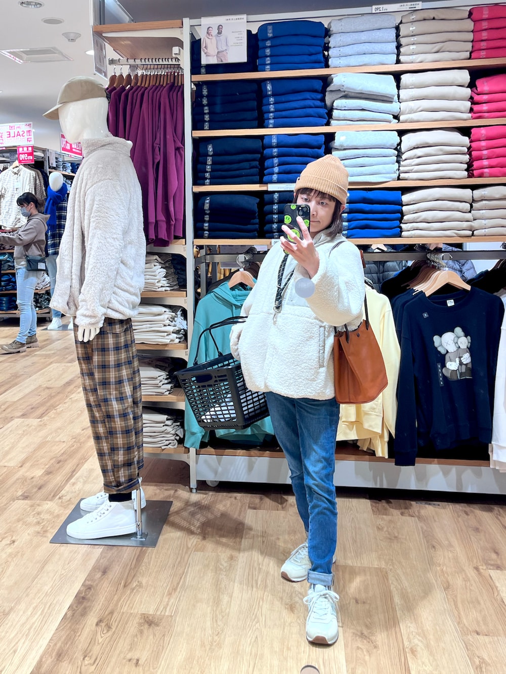 ブルー系のデニムパンツ、ホワイト系のその他アウター、ベージュ系のキャップを着用したレディースの冬コーディネートの2枚目の写真