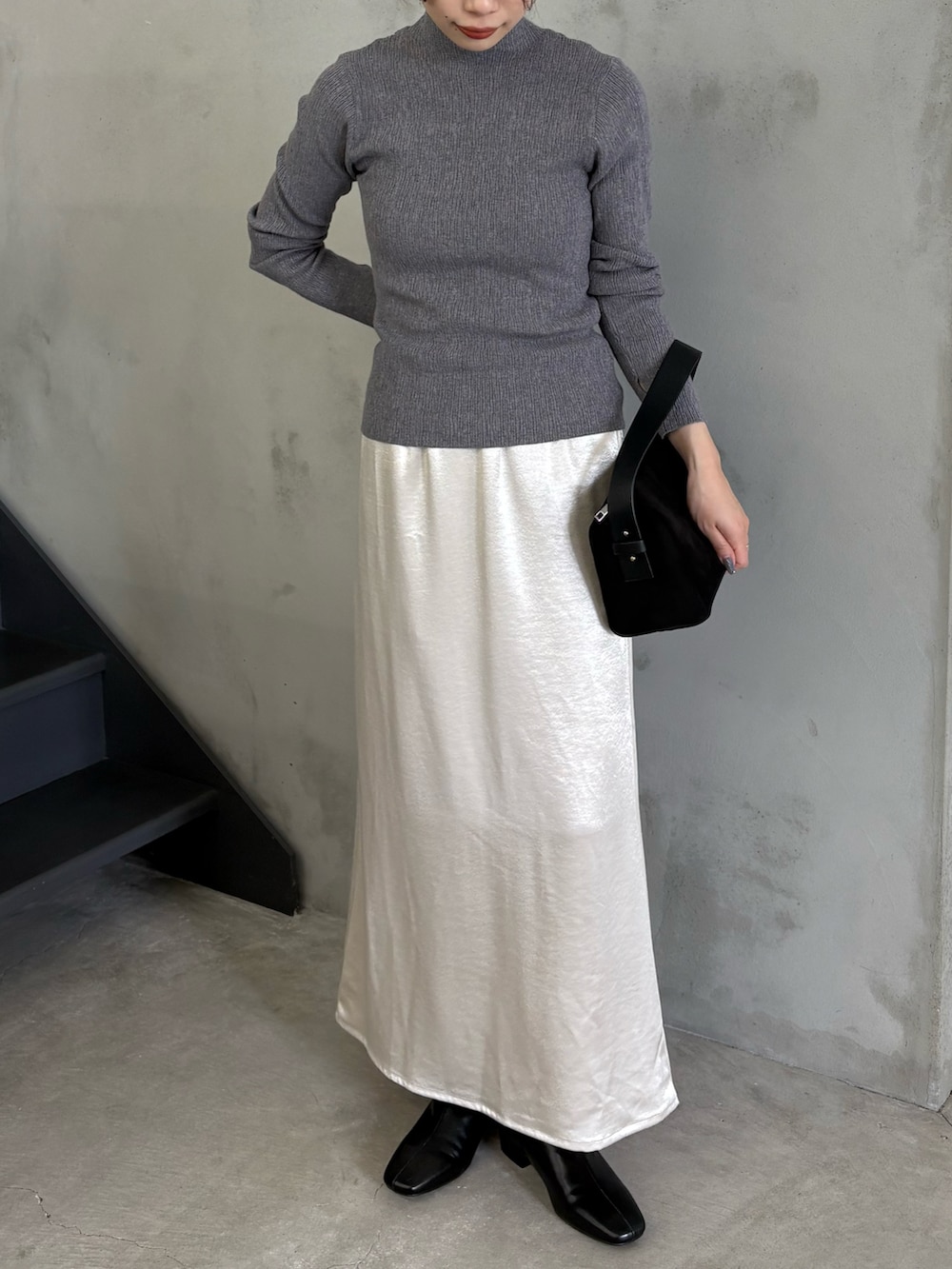 グレー系のTシャツ/カットソー、ブラック系のハンドバッグ、ブラック系のブーツを着用したレディースの秋コーディネートの2枚目の写真