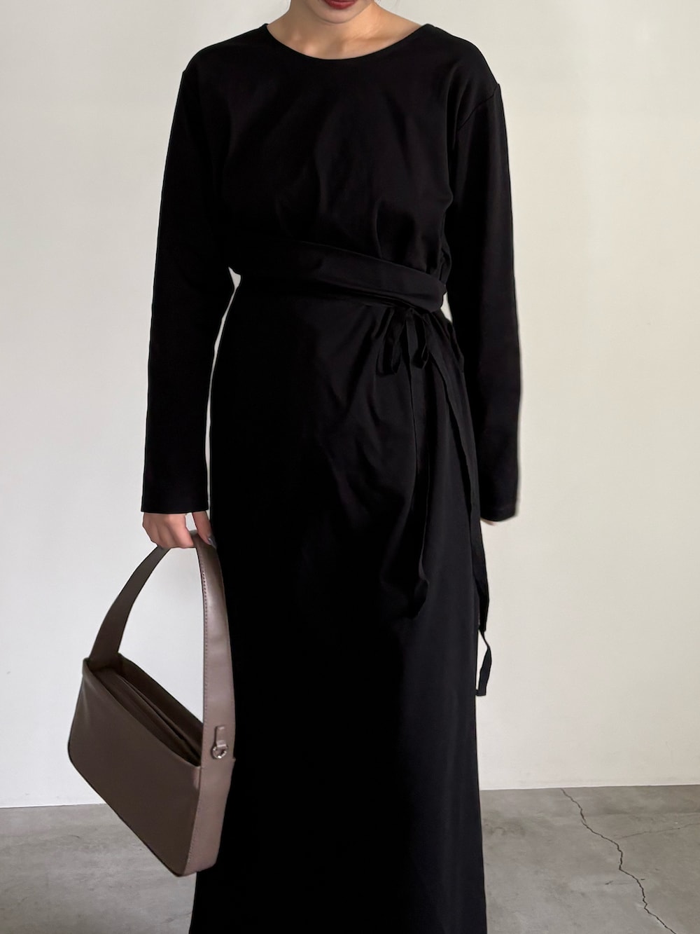 ブラウン系のスラックス、ブラウン系のショルダーバッグ、ブラック系のサンダルを着用したレディースの夏コーディネートの5枚目の写真