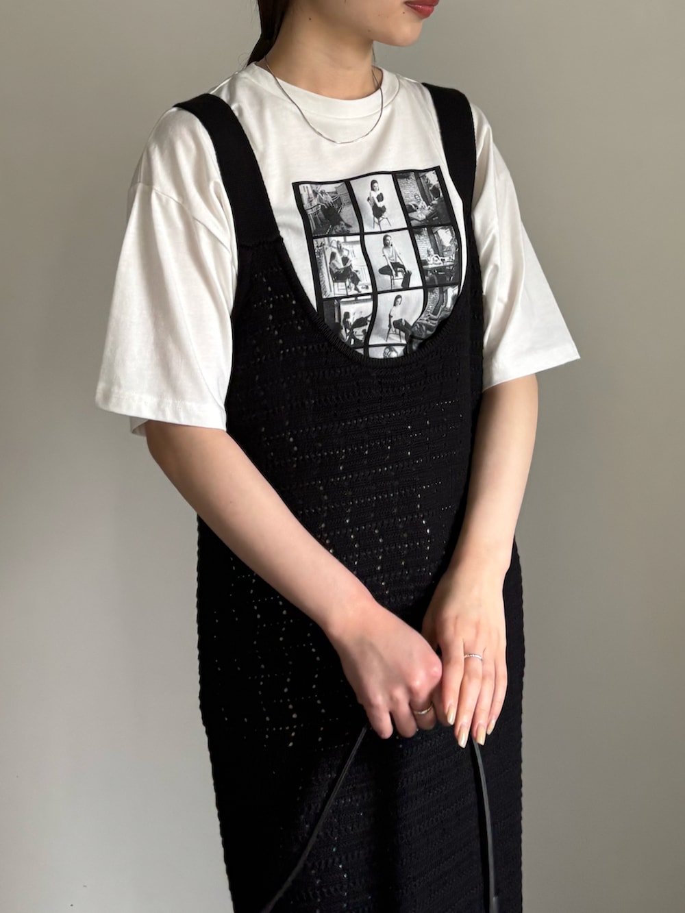 ホワイト系のTシャツ/カットソー、ブラック系のワンピース、ブルー系のデニムパンツを着用したレディースの春コーディネートの4枚目の写真