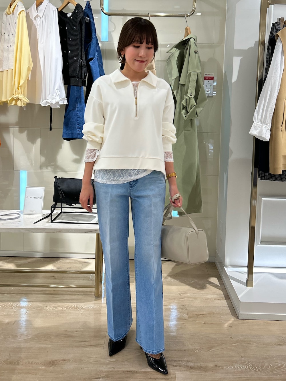 ホワイト系のスウェット、ホワイト系のTシャツ/カットソー、ブルー系のデニムパンツを着用したレディースの冬コーディネートの2枚目の写真