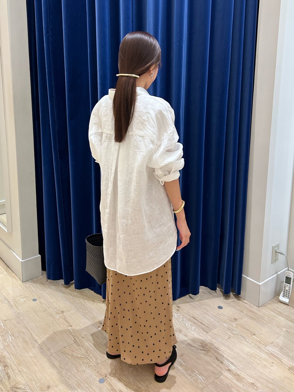 ホワイト系のシャツ/ブラウス、ブラック系のかごバッグ、ブラウン系のスカートを着用したレディースの夏コーディネートの3枚目の写真