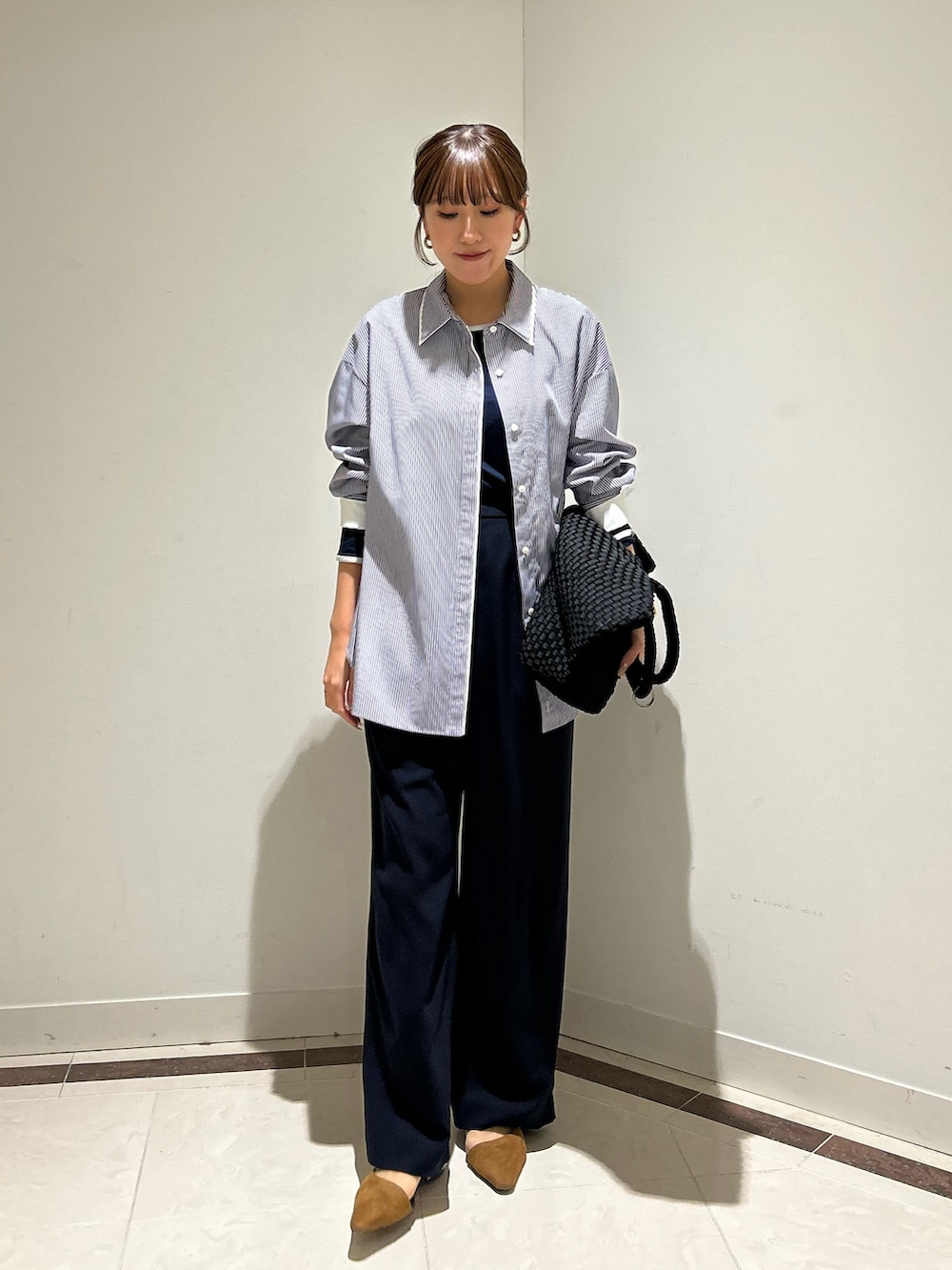 ブルー系のシャツ/ブラウス、ブルー系のTシャツ/カットソー、ブラック系のトートバッグを着用したレディースの冬コーディネートの2枚目の写真